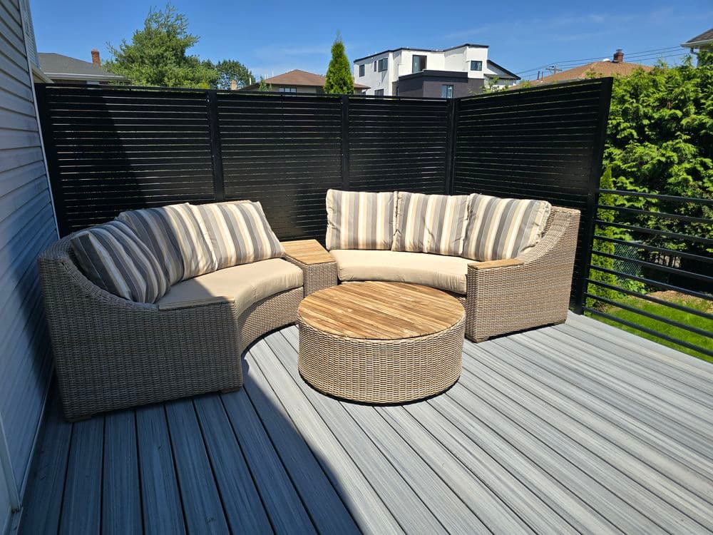 Cozy outdoor seating area with striped cushions and a wooden coffee table on a deck.