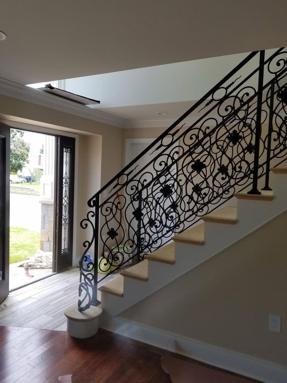 Elegant wrought iron stair railing in a modern interior with natural light.