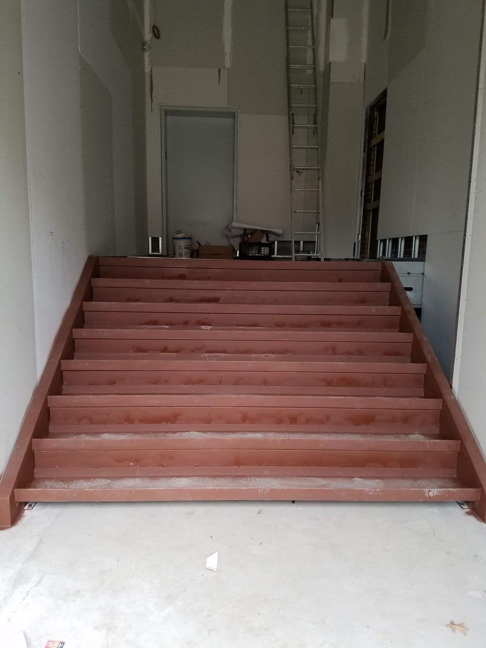 Interior view of unfinished stairs with metal framing in a construction site.