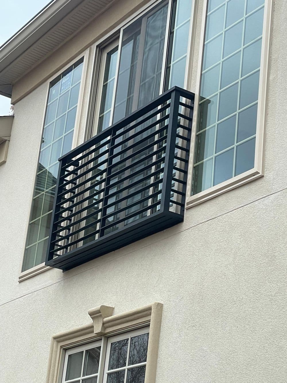 Modern balcony design with horizontal slats on a contemporary house exterior.