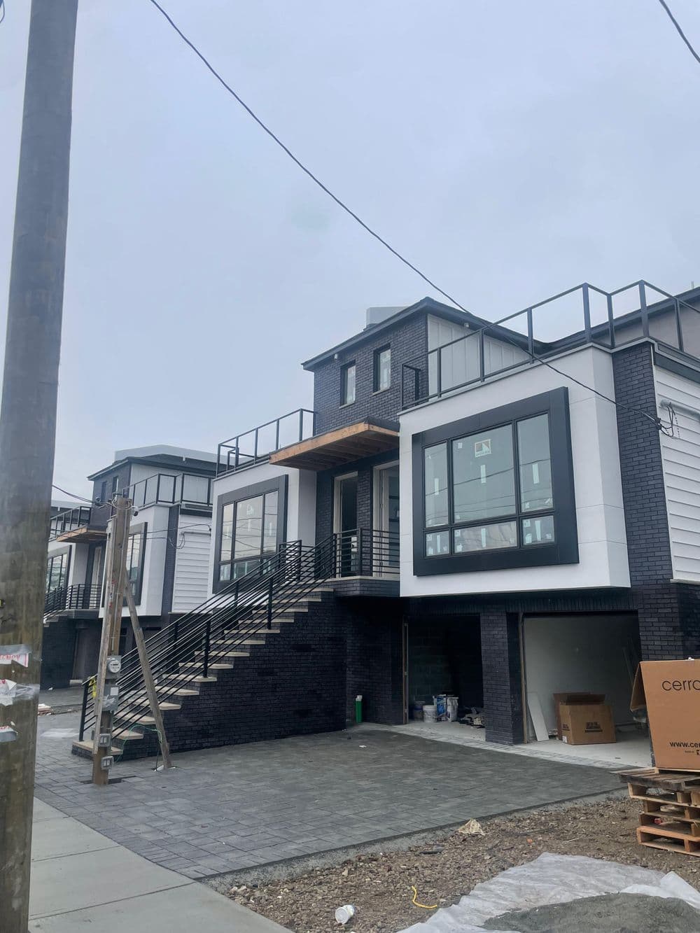Contemporary multi-story home with modern architecture and outdoor stairs.