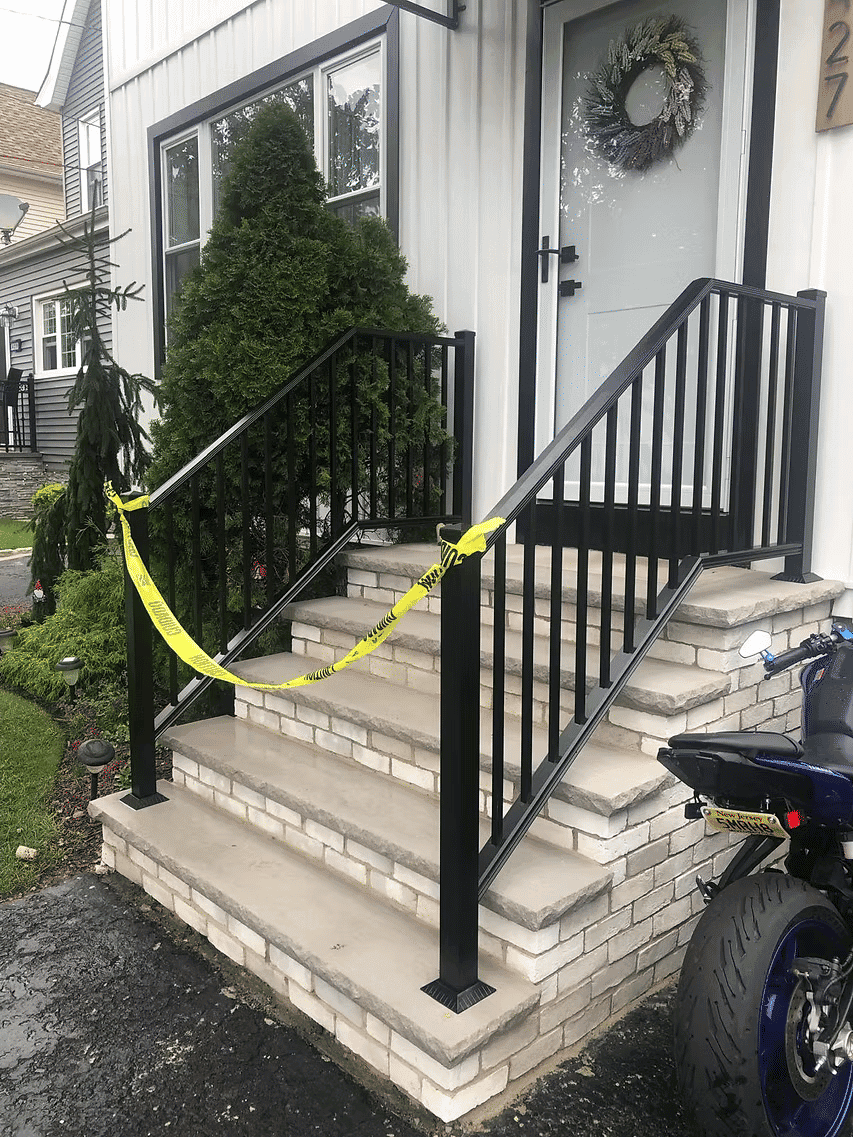 Stairs blocked with caution tape at a residential entrance, indicating safety issue.