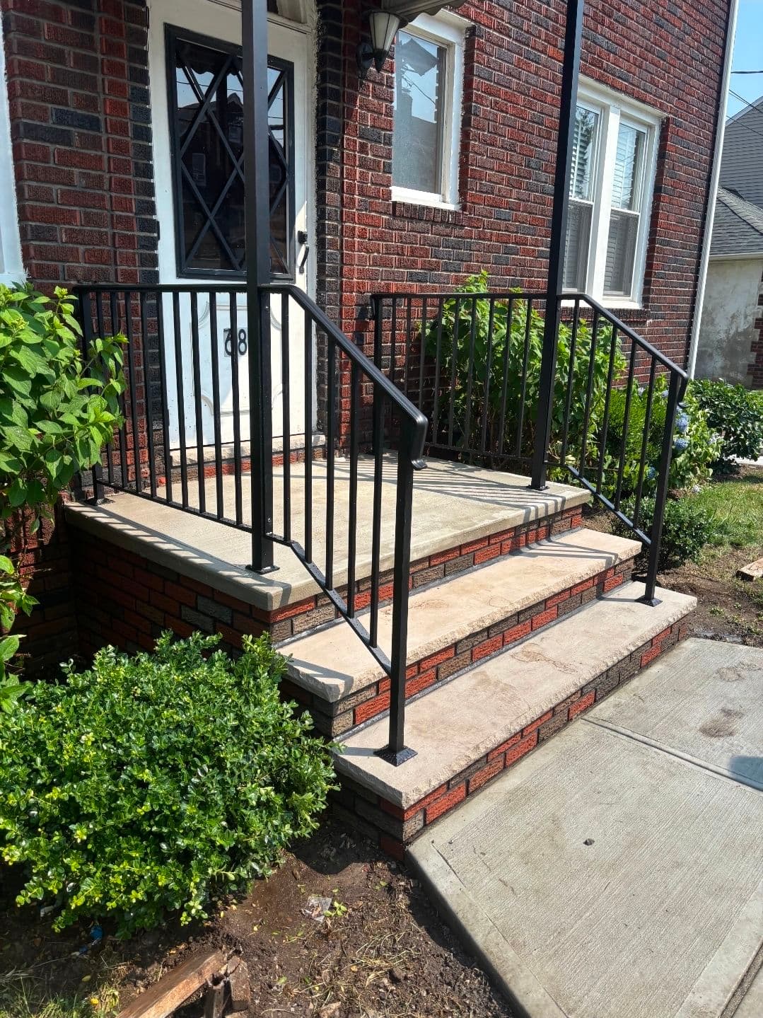 Black Powder-Coated Aluminum Railings on a Brick Row Home Entryway image
