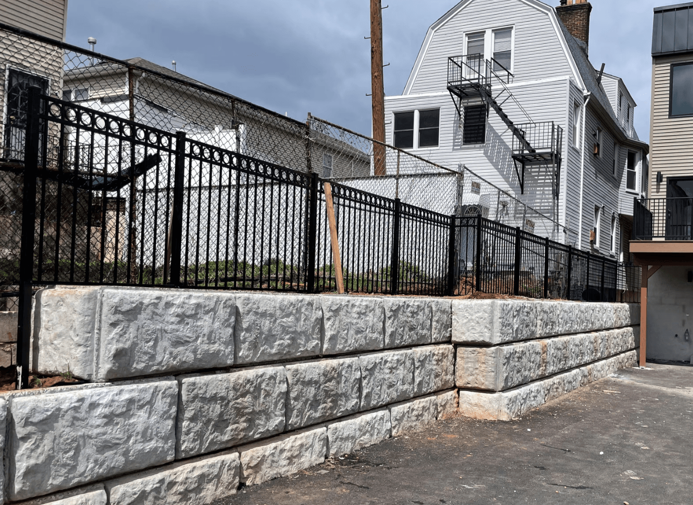 Decorative Black Aluminum Fence Installed Atop a Retaining Wall in Demarest NJ image